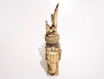 A large Chinese ivory group of Guanyin seated on an elephant, late 19th C.