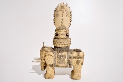 A large Chinese ivory group of Guanyin seated on an elephant, late 19th C.