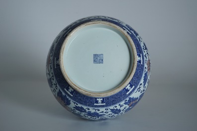 A Chinese copper-red and underglaze blue peony scroll hu vase, Qianlong mark, 19th C.