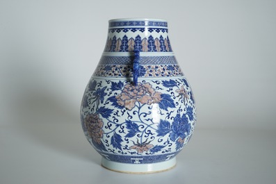 A Chinese copper-red and underglaze blue peony scroll hu vase, Qianlong mark, 19th C.