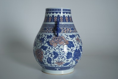 A Chinese copper-red and underglaze blue peony scroll hu vase, Qianlong mark, 19th C.