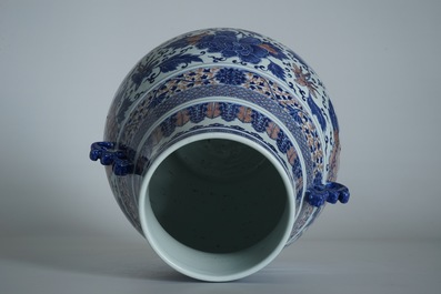 A Chinese copper-red and underglaze blue peony scroll hu vase, Qianlong mark, 19th C.