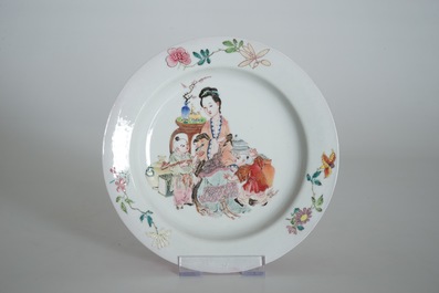 A Chinese famille rose ruby back eggshell plate with a lady and playing boys, Yongzheng
