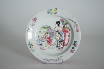 A Chinese famille rose ruby back eggshell plate with a lady and playing boys, Yongzheng