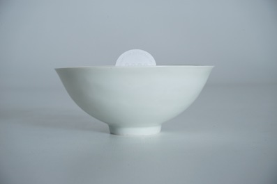 A Chinese monochrome white eggshell anhua bowl with applied design, Yongzheng mark, 19/20th C.