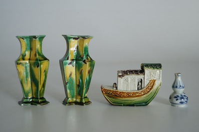 A pair of spinach and egg lozenge-shaped vases, a verte biscuit model of a boat and a miniature vase, Kangxi