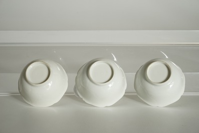 Three blanc de Chine cups and saucers with floral anhua design, Yongzheng/Qianlong