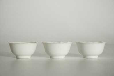 Three blanc de Chine cups and saucers with floral anhua design, Yongzheng/Qianlong