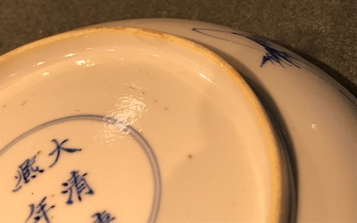 A pair of Chinese blue and white plates with a sage on a donkey, Kangxi mark and of the period