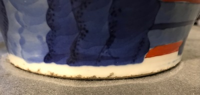 A pair of Chinese wucai baluster vases with carved lids and bases, 19th C.