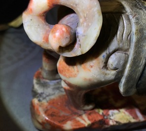 A Chinese soapstone figure of the immortal Vaishravana on a Buddhist lion, Kangxi/Qianlong