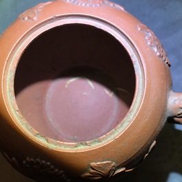 Een Chinese Yixing steengoed theepot met reli&euml;fdecor, Kangxi