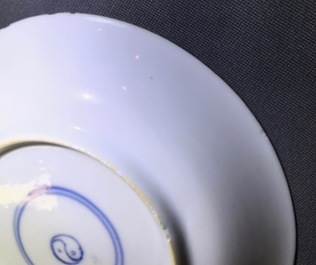 A Chinese famille verte cup and saucer with yin-yang mark, Kangxi