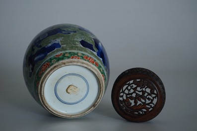A Chinese famille verte jar with wooden cover and stand, Kangxi