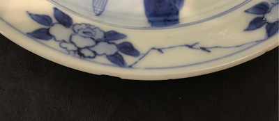 A small Chinese blue and white plate with a monk near the water, Transitional period