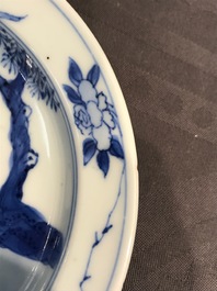 A small Chinese blue and white plate with a monk near the water, Transitional period