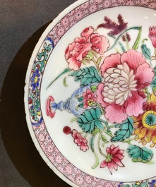 A fine Chinese famille rose cup and saucer with a flowervase, Yongzheng