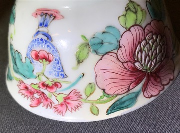 A fine Chinese famille rose cup and saucer with a flowervase, Yongzheng