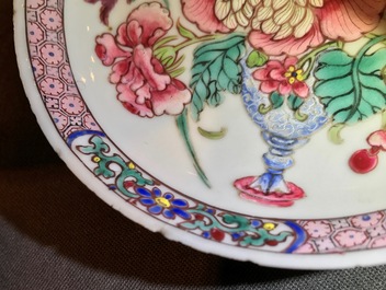 A fine Chinese famille rose cup and saucer with a flowervase, Yongzheng