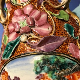 A pair of Chinese famille rose relief-decorated mandarin vases, Qianlong