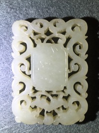 A Chinese white jade plaque with dragons and Taoist symbols, 19th C.