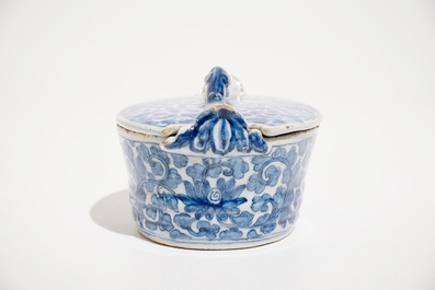 A Dutch Delft blue and white butter tub with chinoiserie design of peony scrolls, 18th C.