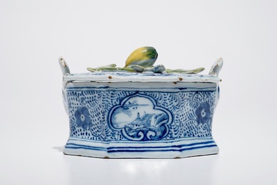 A Dutch Delft blue and white butter tub with polychrome finial, 18th C.