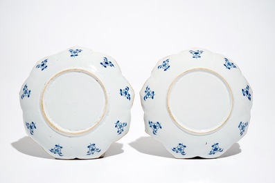 A pair of Dutch Delft blue and white lotus-shaped plates, 18th C.