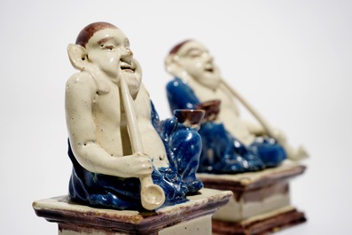 A pair of German faience models of Buddhas in Delft style, 1st half 18th C.