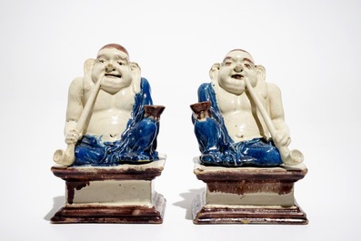 A pair of German faience models of Buddhas in Delft style, 1st half 18th C.