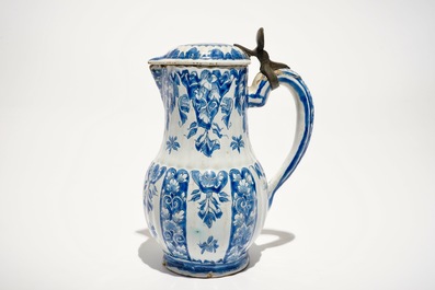 A Dutch Delft blue and white jug and cover with pewter mount, 18th C.