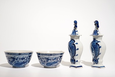 A pair of Dutch Delft blue and white bowls and a pair of vases and covers, 18th C.