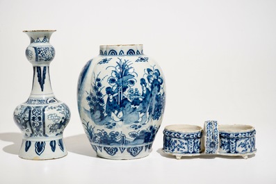 Two Dutch Delft blue and white chinoiserie vases and a cruet stand, 17/18th C.