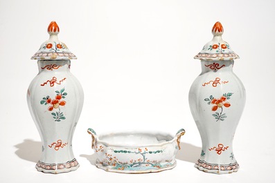 A pair of polychrome Dutch Delft petit feu Kakiemon style vases and a butter tub, 18th C.