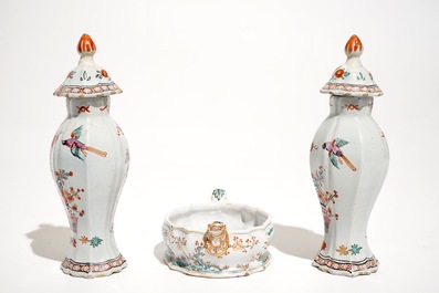 A pair of polychrome Dutch Delft petit feu Kakiemon style vases and a butter tub, 18th C.