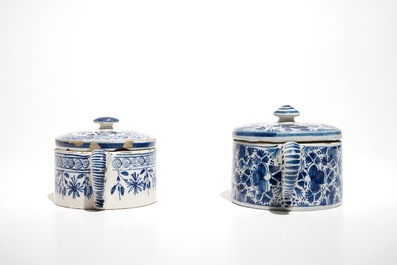A pair of Dutch Delft blue and white dishes with cherubs and two sugar pots, 18th C.