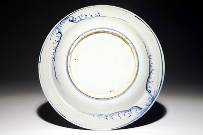 A Chinese blue and white dish with figures in a landscape, Transitional period