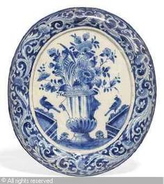 A pair of polychrome English Delftware plaques with a flowervase, 1st half 18th C.