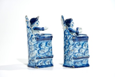 A pair of Dutch Delft models of seated children, 18th C.