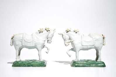A pair of white Dutch Delft circus horses on a green base, 18th C.