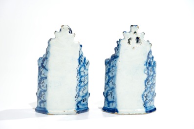 A pair of Dutch Delft models of seated children, 18th C.