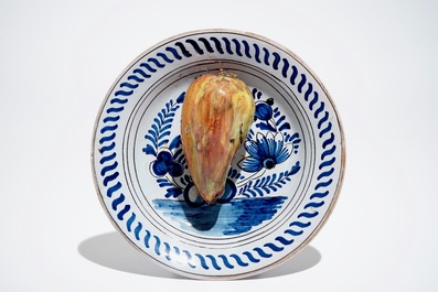 A polychrome Dutch Delft trompe l'oeil plate with a pear, 19th C.