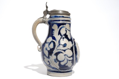 A Westerwald stoneware pewter-mounted jug with a tavern scene, 17th C.