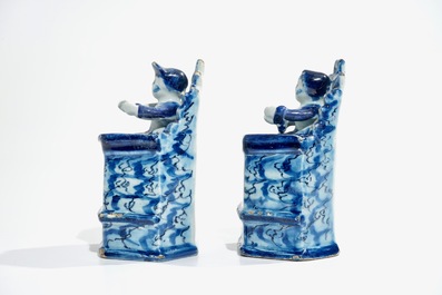 A pair of Dutch Delft models of seated children, 18th C.