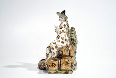 A French faience ink stand modelled as a seated Chinese, Lille, 18th C.