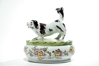 A polychrome Dutch Delft butter tub with a dog, 18th C.