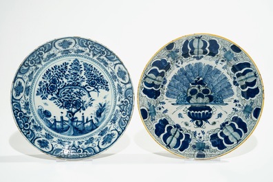 Five Dutch Delft blue and white plates with dragons, tea trees and a peacock's tail, 17/18th C.