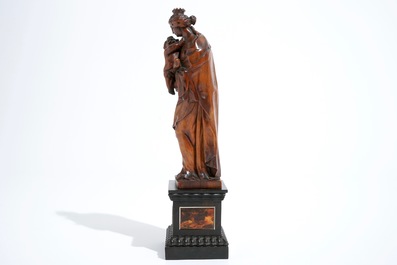 A carved boxwood Madonna with child on tortoise veneer base, 17th C.