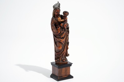 A carved and partial gilt boxwood Madonna with child on rosewood base, 16/17th C.