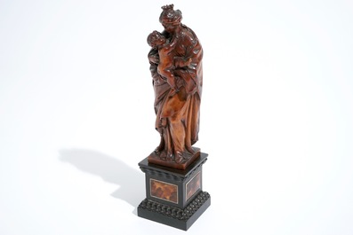 A carved boxwood Madonna with child on tortoise veneer base, 17th C.